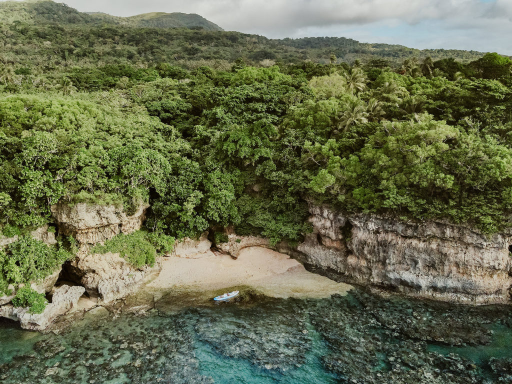 couple taking a kayak to a secret beach to celebrate their beach  elopement