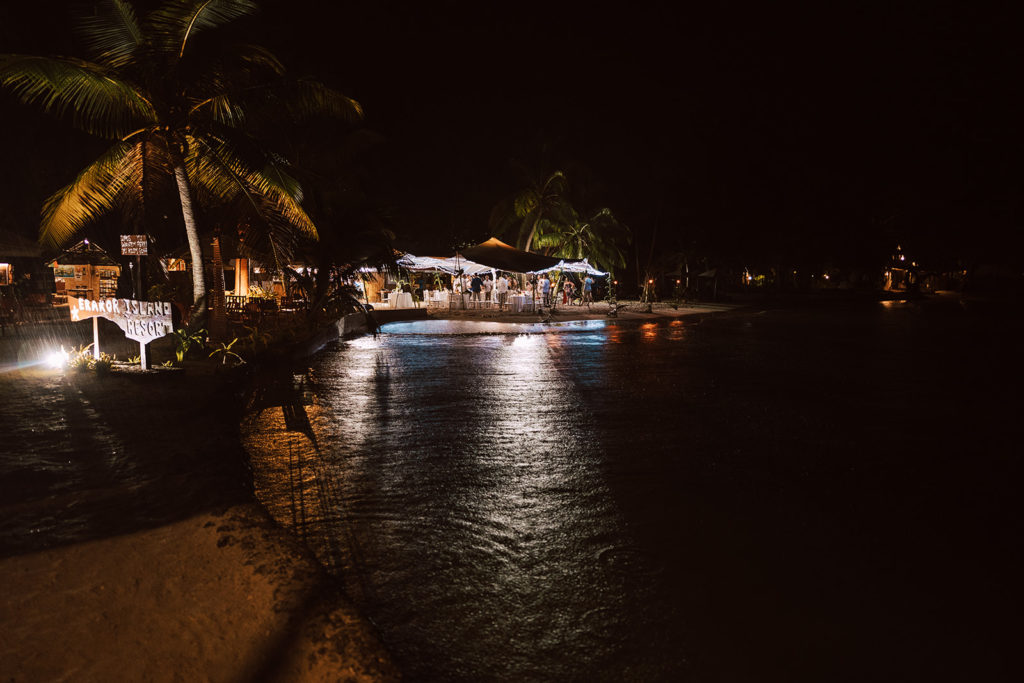 Erakor island wedding marquee by the beach lit up for the wedding reception