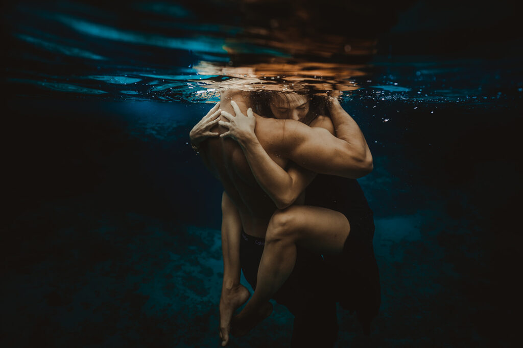 An underwater portrait of a couple in a tight hug during their pre-wedding photoshoot